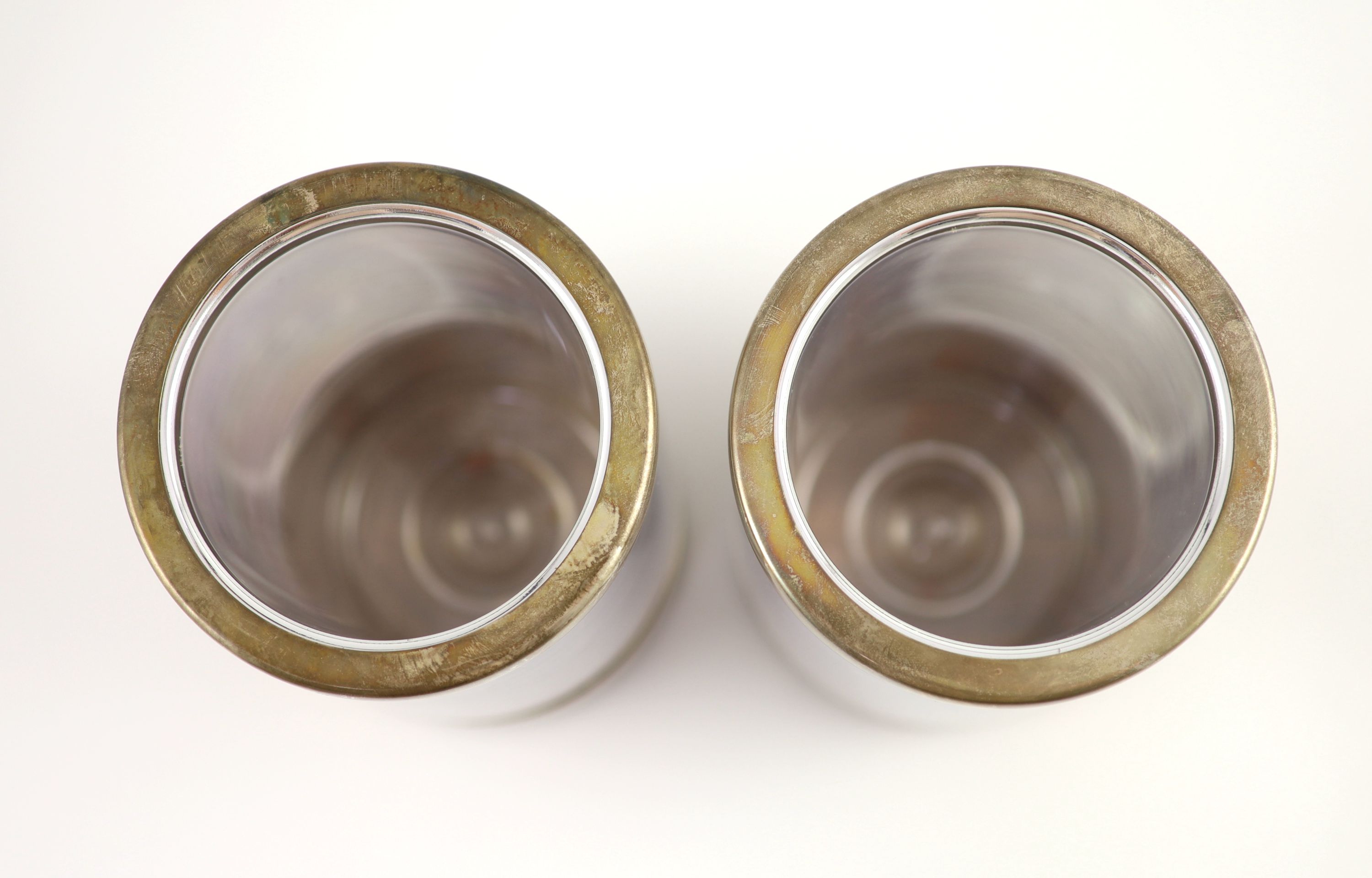 A pair of textured silver bottle coasters by Adrian Gerald Benney, with removeable silver mounted plastic liners